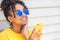 Girl teenager teen female young African American woman wearing sunglasses using cell phone