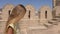 Girl teenager walking on background stony fortress during summer excursion