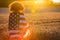 Girl Teenager Wrapped in USA Flag in Field at Sunset