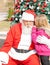 Girl Telling Wish In Santa Claus\'s Ear