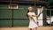 A girl tennis player is practicing proper racket hitting technique. A young lady athlete is training before a match. A