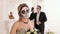 Girl with a terrible make-up in the form of a skull in a room with a man in suit