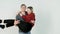 Girl throwing herself in the arms of her boyfriend on white background. Young girl jumps on boyfriend arm