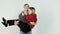 Girl throwing herself in the arms of her boyfriend on white background. Young girl jumps on boyfriend arm