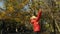 Girl throwing leaves in Autumn in slow motion