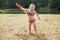 Girl throws sand. Beautiful girl playing with sand on beach. child having fun. vacation happiness and freedom concept