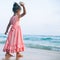 Girl throws a stone at sea.