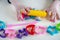 Girl toddler hands playing colorful play dough with plastic molds and yellow rolling pin