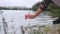 The girl touches the sand on the river with her fingers. Close-up shot of a woman\\\'s hand on a background of sand