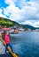 Girl tourist on the background of the sea bay and old wooden houses on the embankment of Bergen