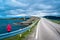 Girl tourist on the background of Storseisundet Bridge Storseisundbrua. Atlantic Ocean Road. Norway