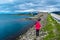 Girl tourist on the background of Storseisundet Bridge Storseisundbrua. Atlantic Ocean Road. Norway