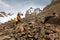 Girl tourist climbs the rocky slope of the mountain