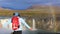 Girl tourist enjoys the view of the Godafoss waterfall