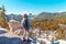 Girl tourist photographs on the phone an autumn mountain landscape