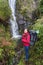 Girl tourist photographs waterfall. Portugal .