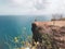 Girl tourist standing on the cliff