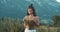 Girl tourist standing on cliff at seaside. The mood of cinematography, gentle tones, alpine meadows and Austrian