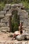 Girl tourist in the summer against the backdrop of ancient ruins