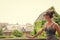 Girl tourist sunglasses enjoy view Krakow old city. Woman stand in front of architectural horizon with roofs and