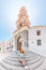 Girl tourist visiting famous monastery Panormitis on the island of Symi, Greece. Dodecanese sightseeing and mediterranean