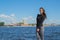 Girl tourist walks along the embankment of the Neva river in St