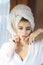 Girl with towel on head relaxing, after spa or shower