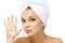 Girl with towel on head shows cream smiley on palm