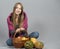 Girl with traditional autumnal basket with pumpkins