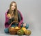 Girl with traditional autumnal basket with pumpkins