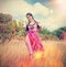 Girl in traditional bavarian dirndl holds beer mug