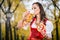 Girl in traditional bavarian Tracht drinking beer out of huge mu