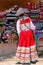 Girl in traditional dress standing at the market in Maca village