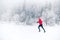 Girl trail running on snow in winter mountains, Poland