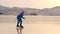 The girl train on ice speed skating. The child skates in the winter in blue sportswear suit, sport glasses. Children