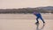 The girl train on ice speed skating. The child skates in the winter in blue sportswear suit, sport glasses. Children