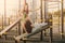 The girl the trainer observes the guy performing the exercise on the press of the urban sports ground on an inclined bench