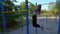 Girl trains on the sports ground in the open air.