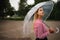 Girl with transparent umbrella in rainy weather