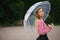 Girl with transparent umbrella in rainy weather