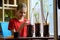 A girl after transplanting seedlings puts signs with the name of the plants