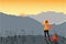 Girl traveler with a backpack meets in the mountains dawn or sunset. Mountain landscape with the setting sun. Vector illustration