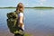 Girl traveler in forest looks at forest. outdoor adventures outdoor. Forest holidays