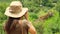 girl traveler in safari style photographs a giraffe in the savannah