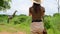 girl traveler in safari style photographs a giraffe in the savannah