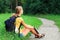 Girl traveler sitting on the grass