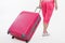 Girl traveller with pink suitcase.