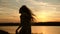 Girl traveller, tourist is dancing. free girl dancing at sunset with long hair in the rays of the sunset. healthy woman