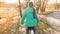 Girl travels by bike on the way. sporty teen ride on a bike. A young girl in a green jacket rides a bicycle on the road