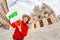 girl travels in Italy. Happy young hipster woman posing with flag in front of the Duomo Cathedral in Siena. Vacation and